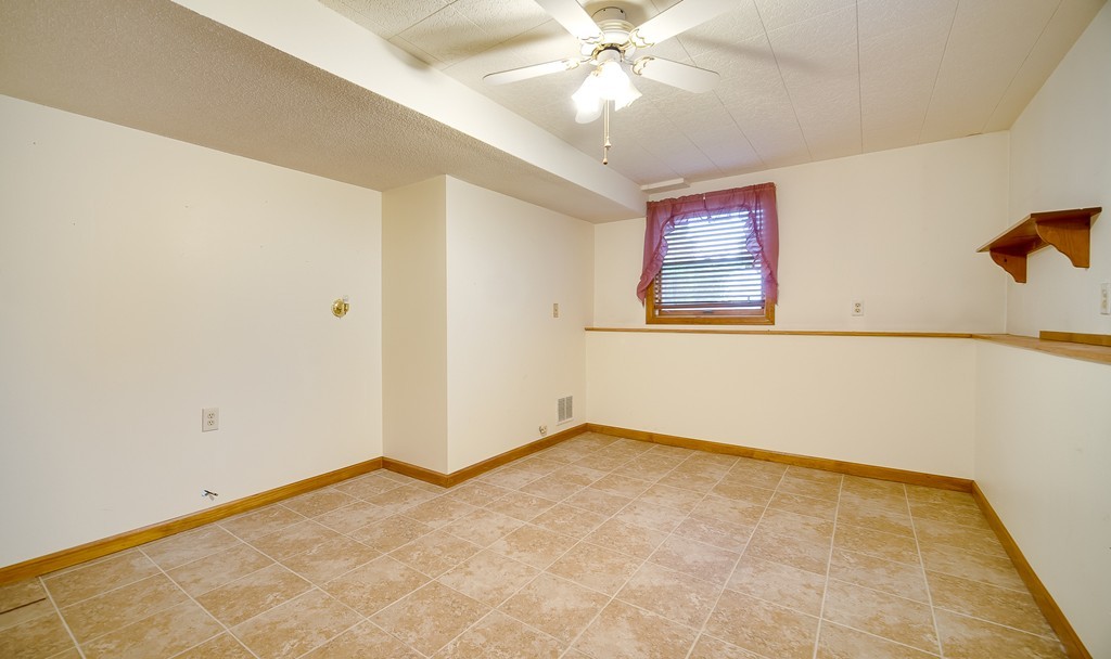 986 Allen Street Springfield, MA 01118 - Photo 14 of 30 an empty room with a ceiling fan and window