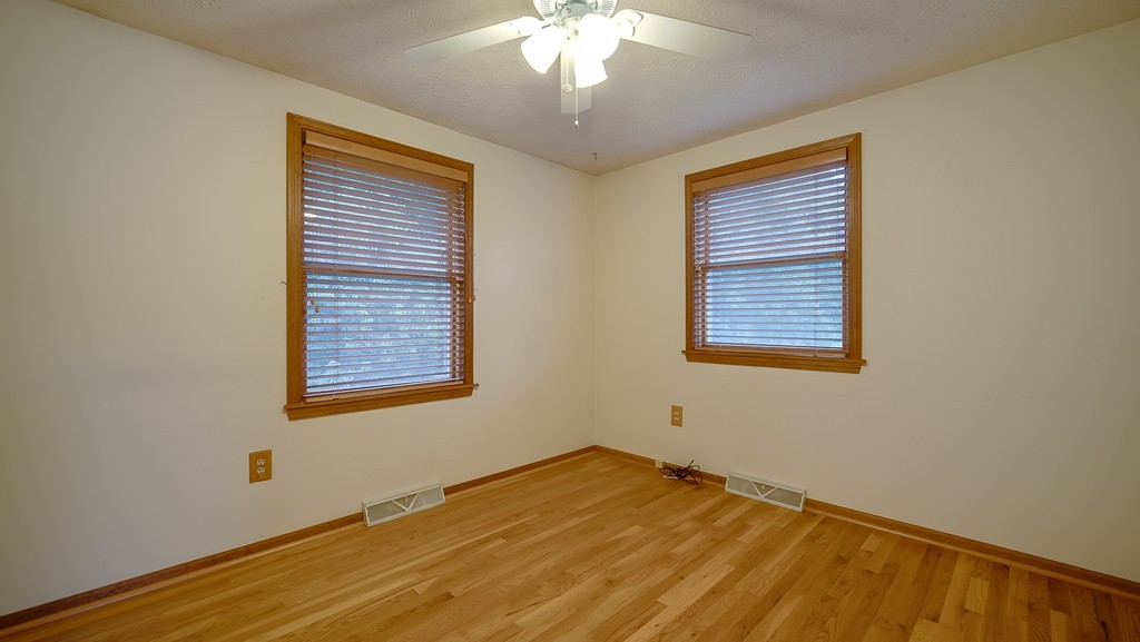 986 Allen Street Springfield, MA 01118 - Photo 18 of 30 a view of an empty room with wooden floor and a window