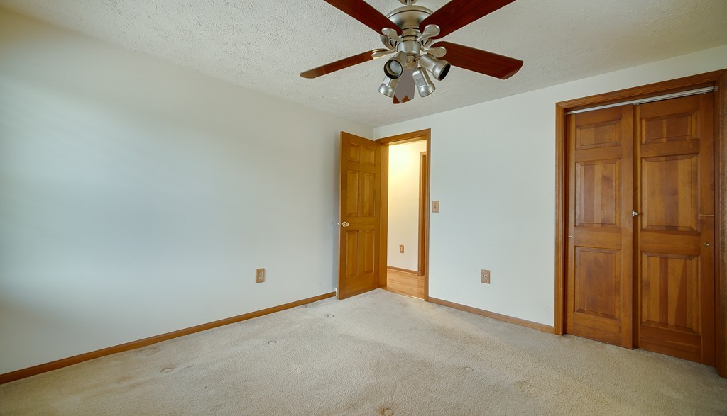 986 Allen Street Springfield, MA 01118 - Photo 21 of 30 an empty room with a chandelier fan