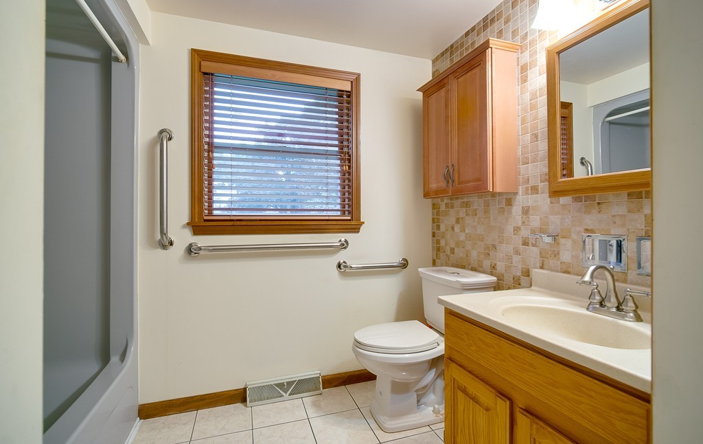 986 Allen Street Springfield, MA 01118 - Photo 24 of 30 a bathroom with a sink a toilet and a window