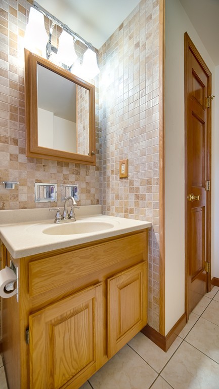 986 Allen Street Springfield, MA 01118 - Photo 25 of 30 a bathroom with a sink vanity and a mirror