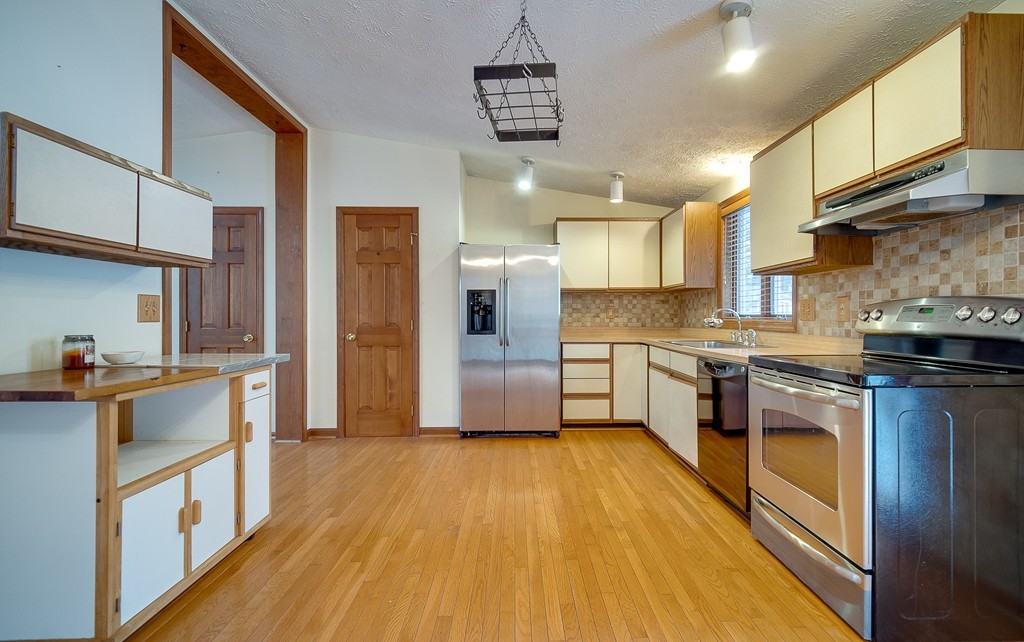 986 Allen Street Springfield, MA 01118 - Photo 3 of 30 a kitchen with stainless steel appliances granite countertop a stove a sink and a refrigerator