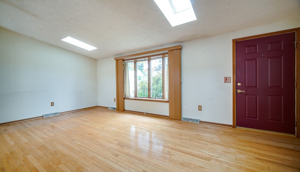 986 Allen Street Springfield, MA 01118 - Photo 9 of 30 a view of an empty room with wooden floor and a window