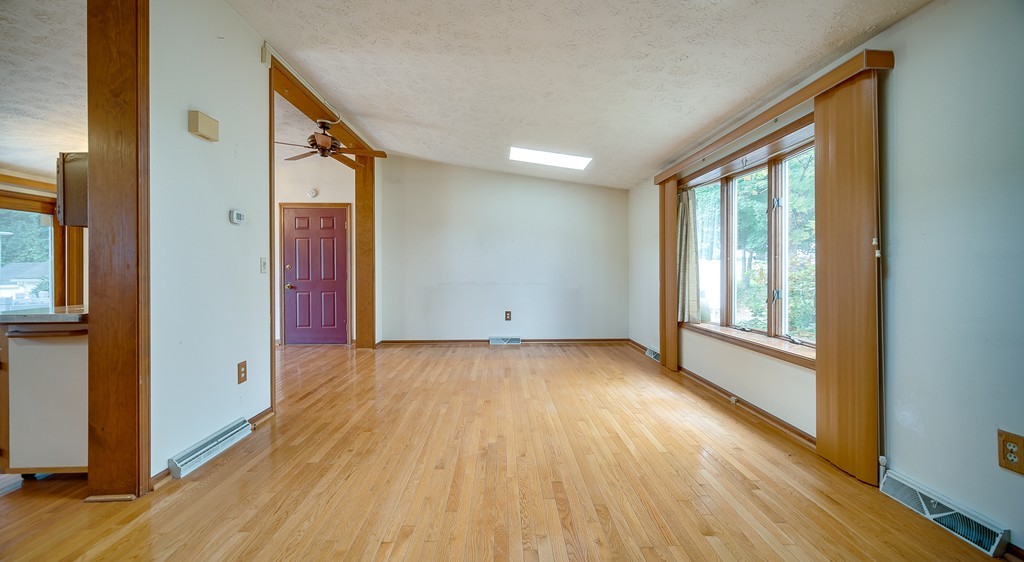 986 Allen Street Springfield, MA 01118 - Photo 10 of 30 a view of an empty room with wooden floor and a window