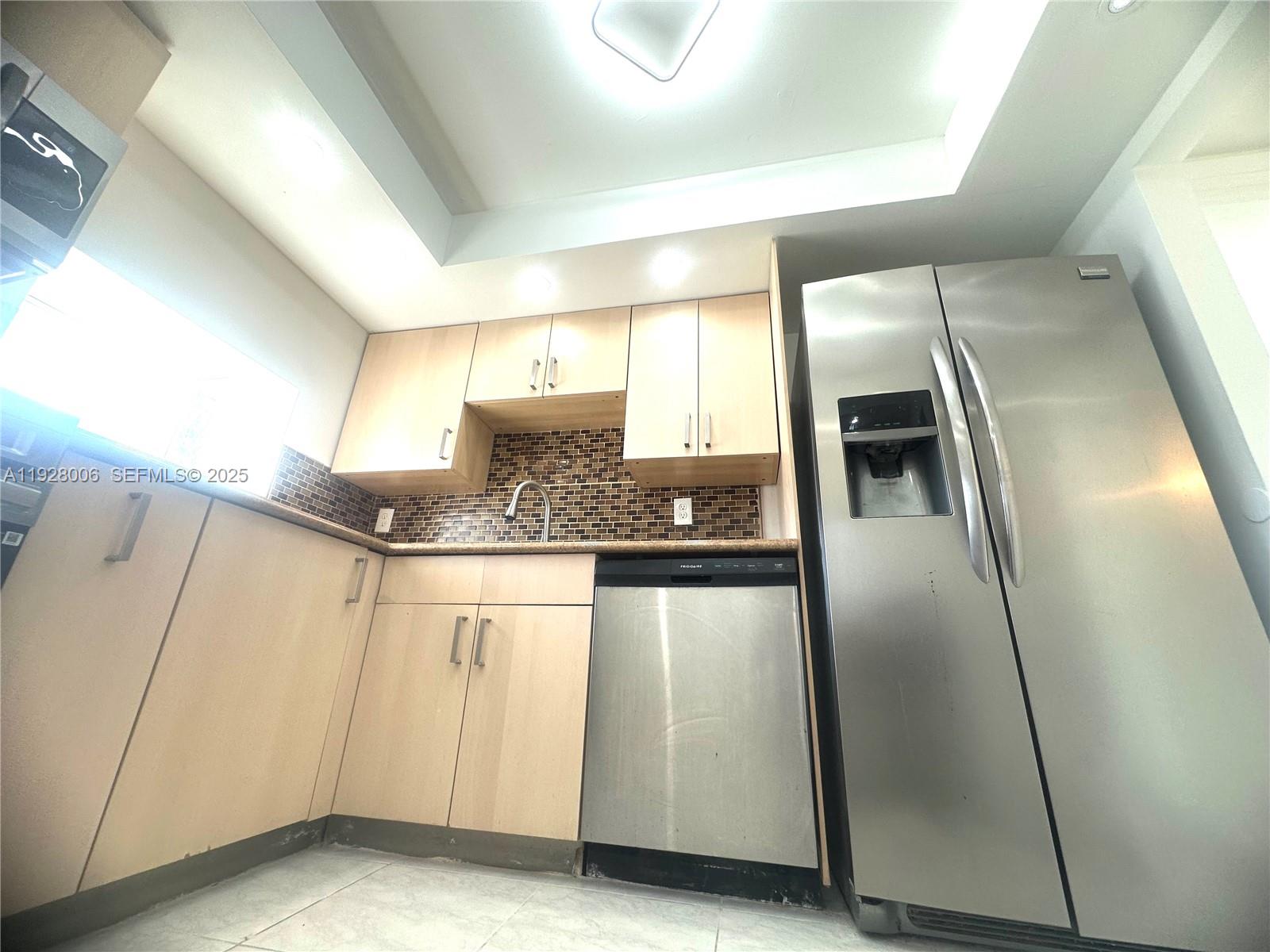 250 180th Drive, Unit 254 Sunny Isles Beach, FL 33160 - Photo 17 of 36 a kitchen with stainless steel appliances granite countertop a refrigerator and a sink