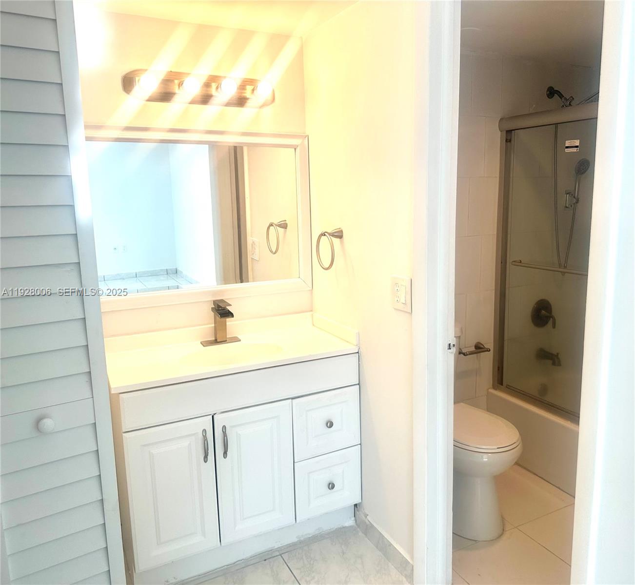 250 180th Drive, Unit 254 Sunny Isles Beach, FL 33160 - Photo 21 of 36 a bathroom with a granite countertop sink a toilet and a shower