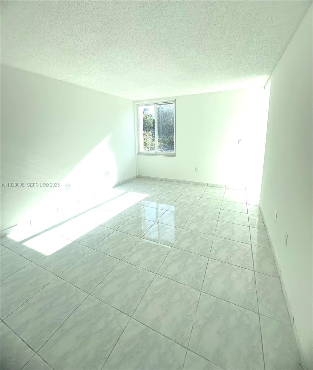 250 180th Drive, Unit 254 Sunny Isles Beach, FL 33160 - Photo 28 of 36 a view of an empty room with a window