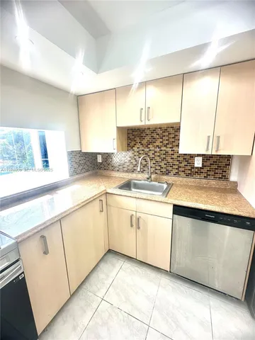 a stove top oven sitting inside of a kitchen