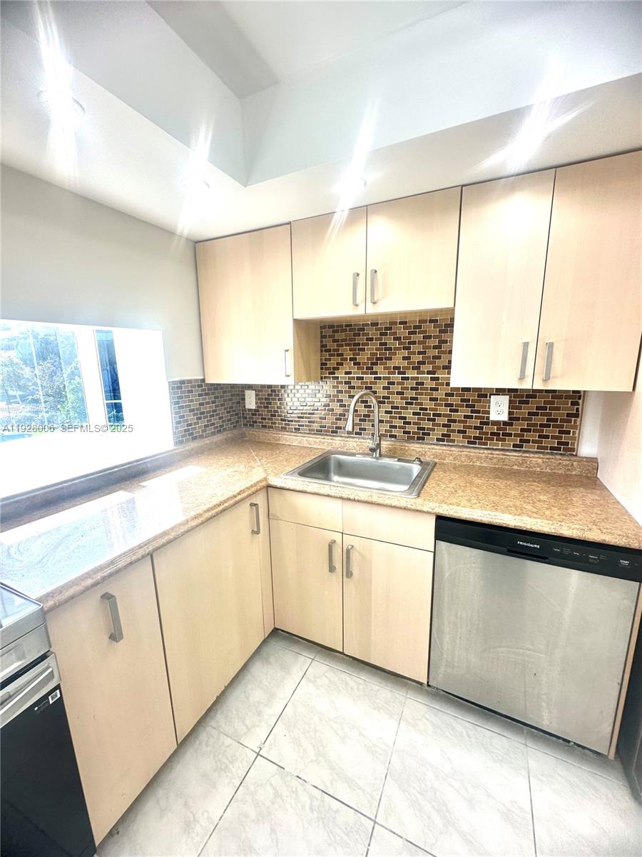 250 180th Drive, Unit 254 Sunny Isles Beach, FL 33160 - Photo 29 of 36 a kitchen with granite countertop white cabinets and white appliances