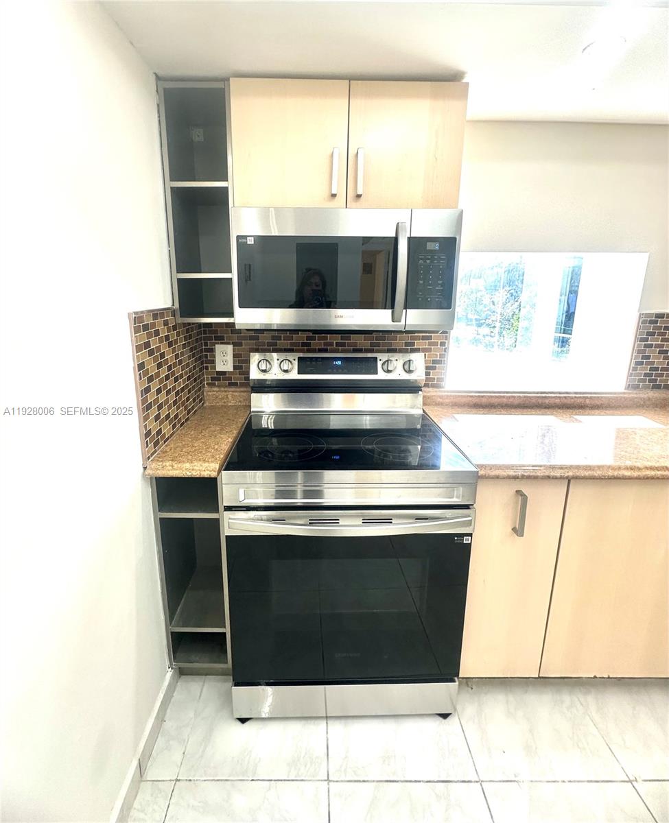 250 180th Drive, Unit 254 Sunny Isles Beach, FL 33160 - Photo 30 of 36 a stove top oven sitting inside of a kitchen