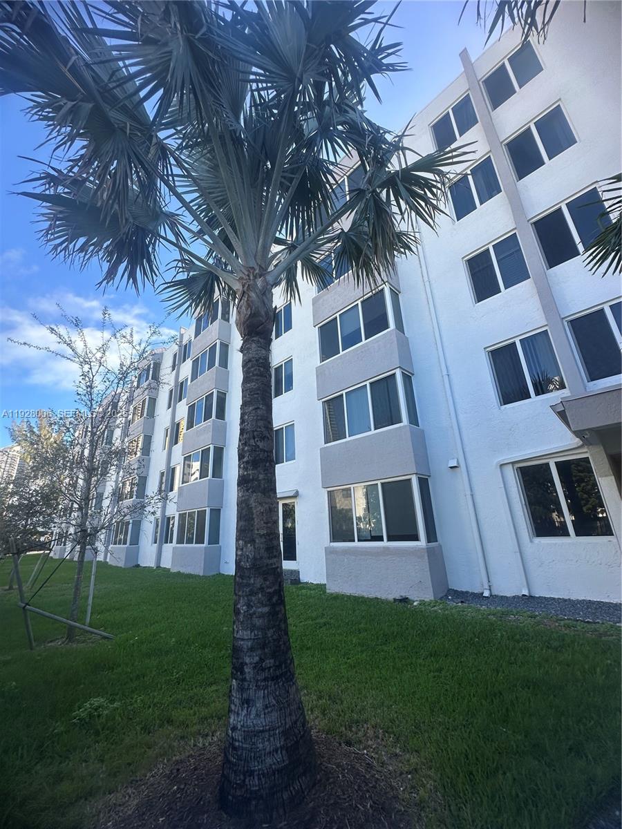 250 180th Drive, Unit 254 Sunny Isles Beach, FL 33160 - Photo 3 of 36 a view of building with yard