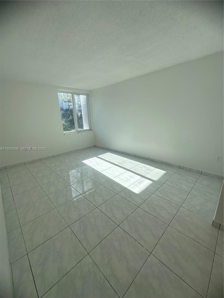 250 180th Drive, Unit 254 Sunny Isles Beach, FL 33160 - Photo 31 of 36 an empty room with windows