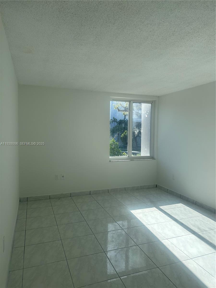 250 180th Drive, Unit 254 Sunny Isles Beach, FL 33160 - Photo 35 of 36 an empty room with windows
