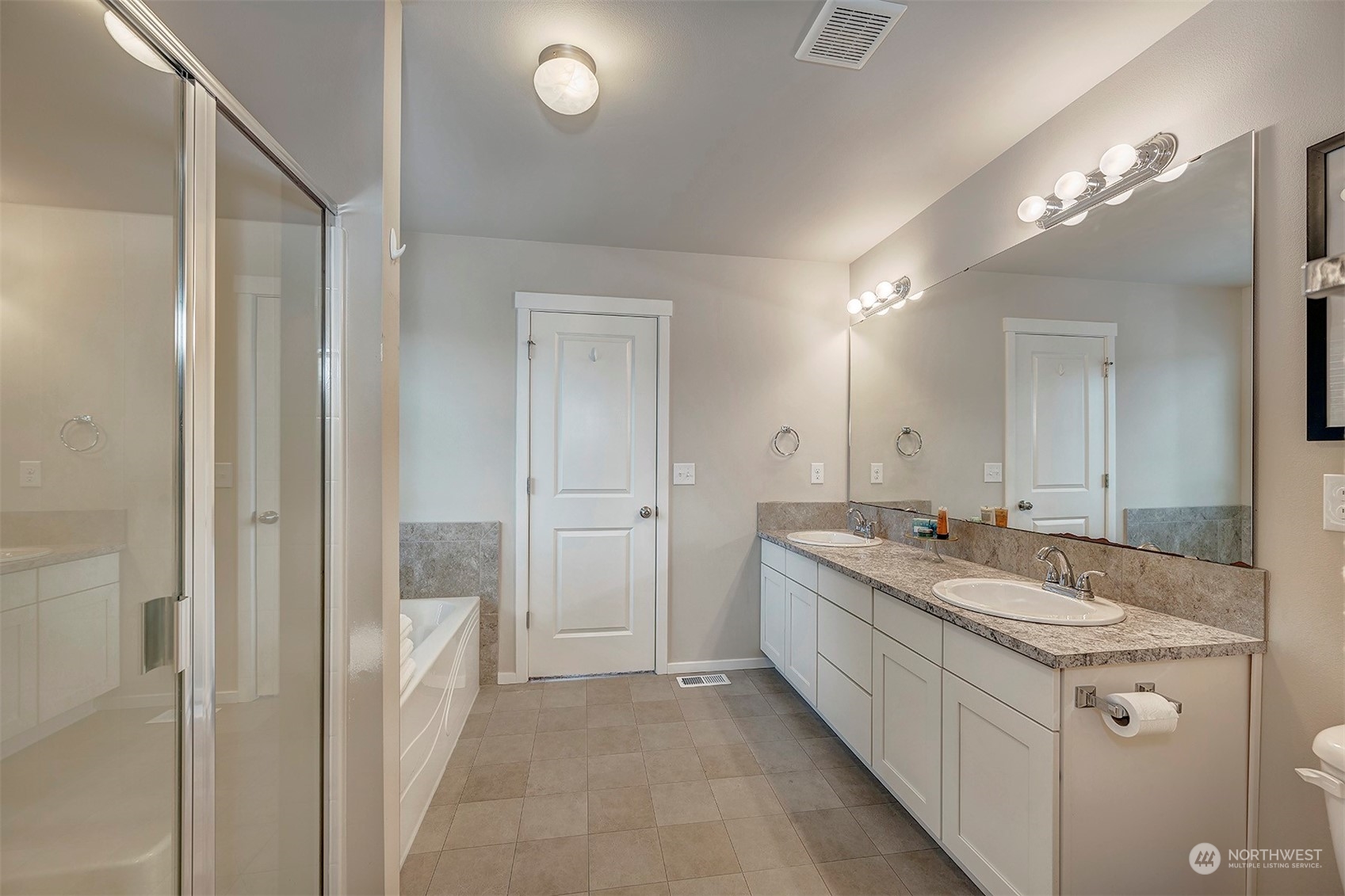 12329 23rd Drive Southeast, Unit 10 Everett, WA 98208 - Photo 14 of 24 a bathroom with a granite countertop double vanity sink a mirror and a shower