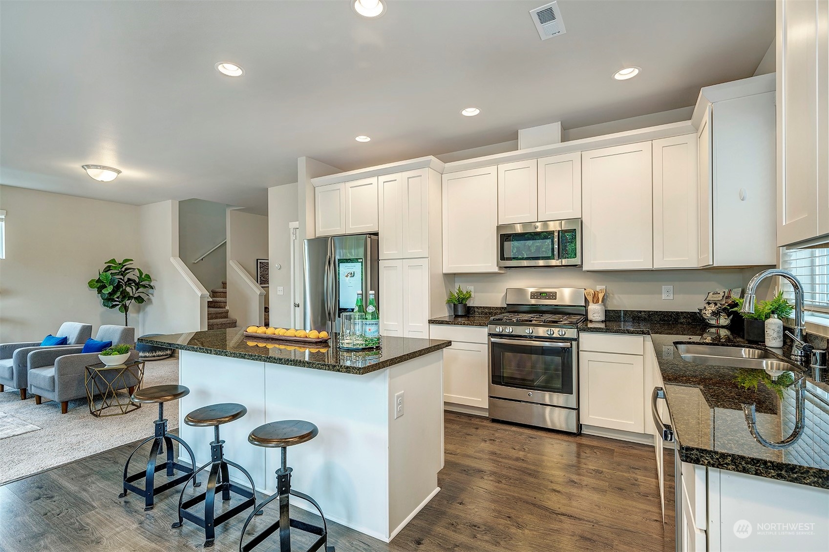 12329 23rd Drive Southeast, Unit 10 Everett, WA 98208 - Photo 9 of 24 a kitchen with stainless steel appliances kitchen island granite countertop a stove and cabinets