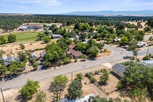 an aerial view of residential houses with outdoor space and river
