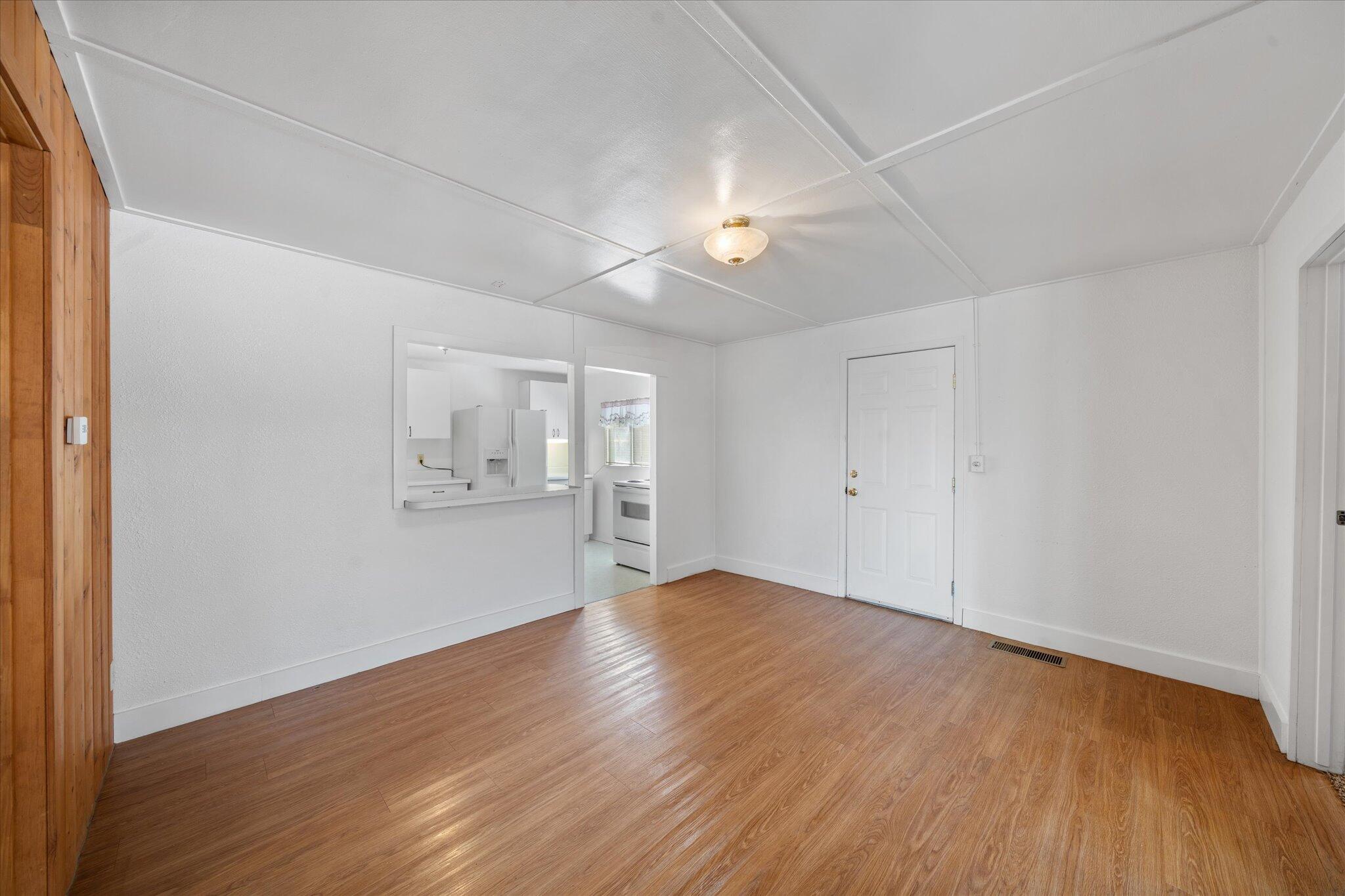 6535 Placer Road Igo, CA 96047 - Photo 4 of 39 an empty room with wooden floor and windows