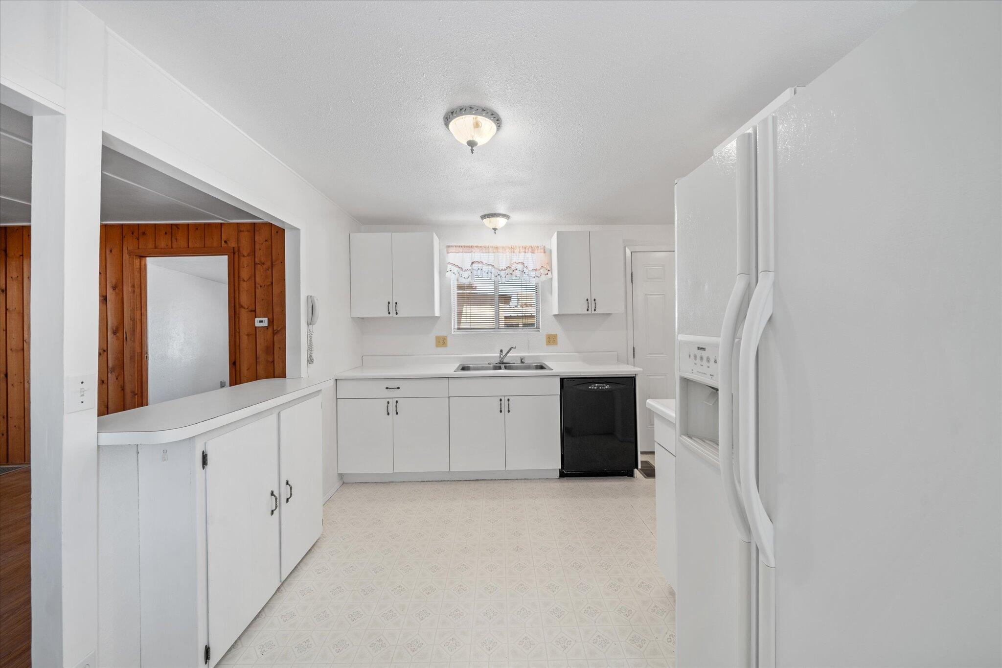 6535 Placer Road Igo, CA 96047 - Photo 7 of 39 a large white kitchen with white cabinets