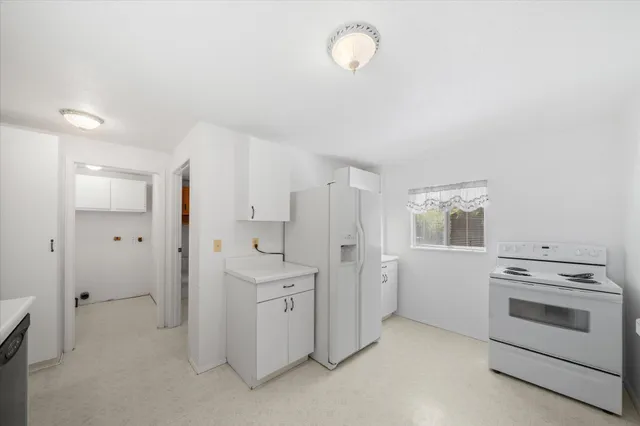 a view of a kitchen with white cabinets