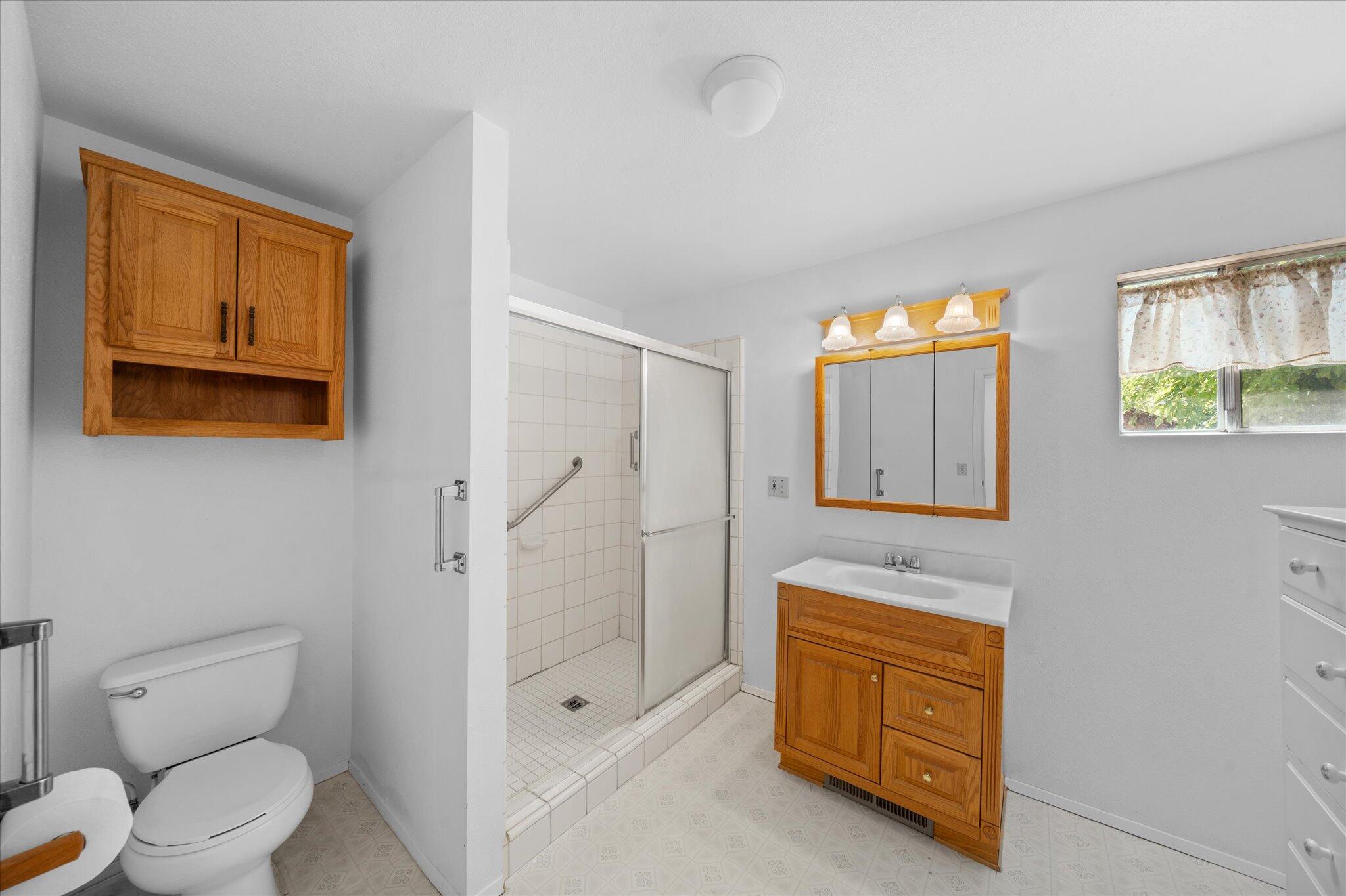 6535 Placer Road Igo, CA 96047 - Photo 9 of 39 a spacious bathroom with a shower toilet sink and mirror