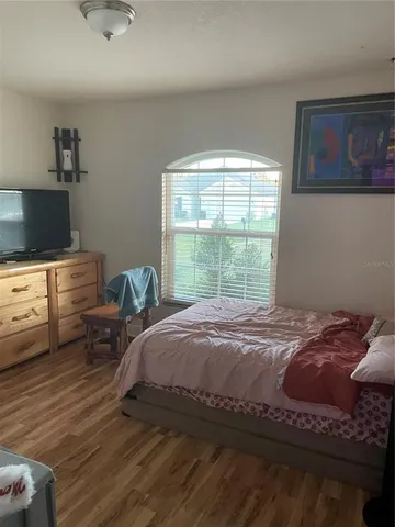 a bed room with a bed and a chair