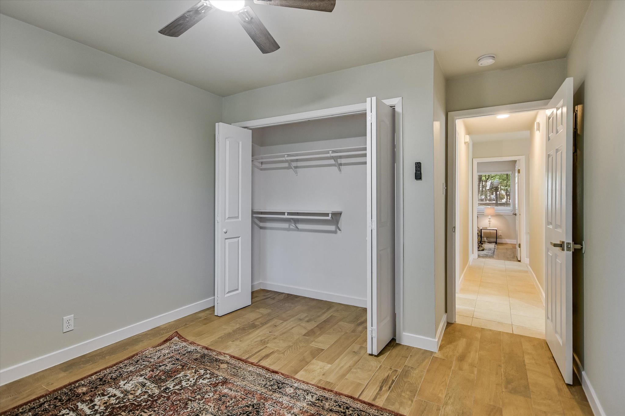 4902 Duval Road, Unit H1 Austin, TX 78727 - Photo 15 of 20 A well-appointed bedroom features ample closet space and durable wood-look flooring.