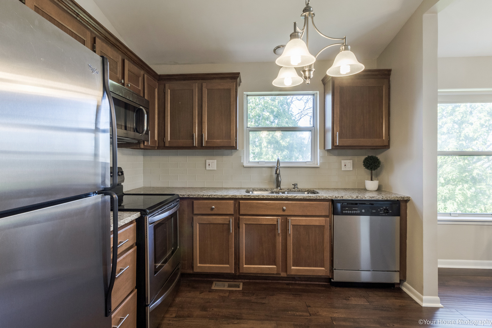 150 West Golf Road, Unit B Libertyville, IL 60048 - Photo 7 of 19 a kitchen with stainless steel appliances granite countertop a sink a stove and a microwave