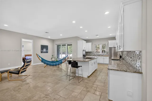 a kitchen with stainless steel appliances granite countertop a sink and cabinets