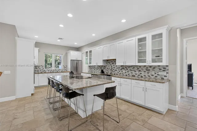 a kitchen with a stove sink and cabinets