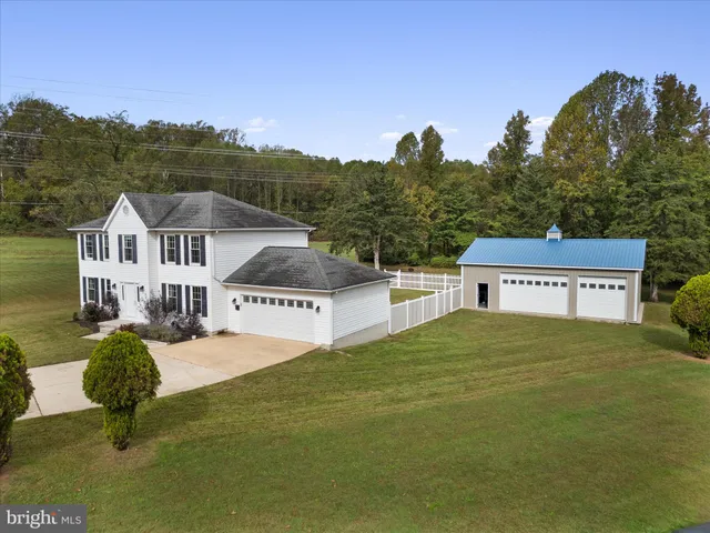 a view of a house with a yard and sitting area