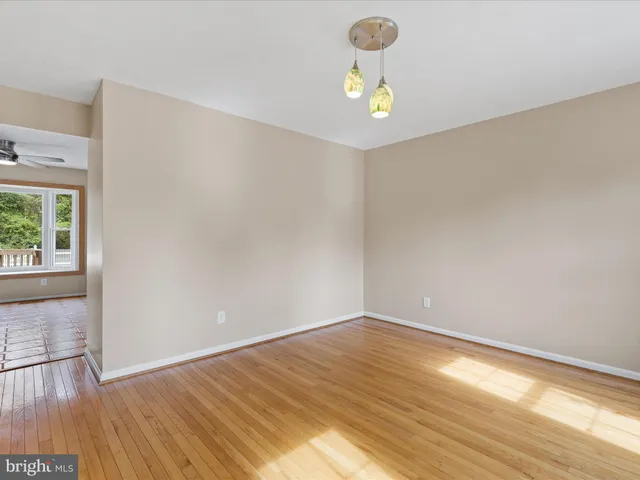 a view of livingroom with window ceiling fan and hardwood floor
