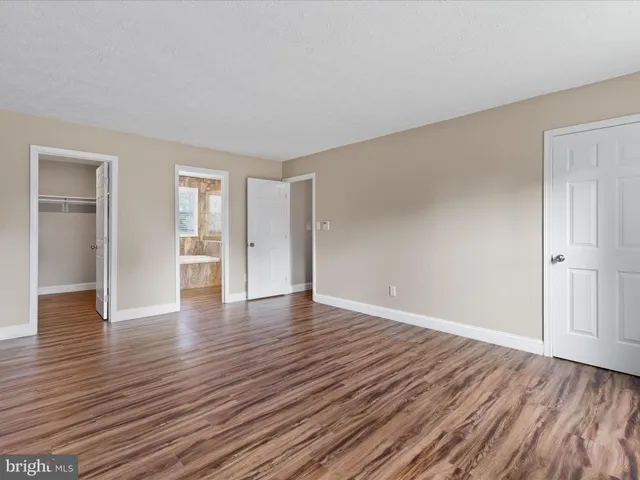 a view of a room with wooden floor and staircase