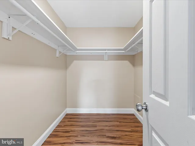 a bathroom with a sink a toilet a mirror and shower