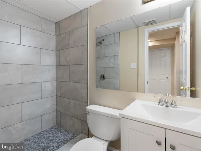 a white house with a small yard and wooden fence