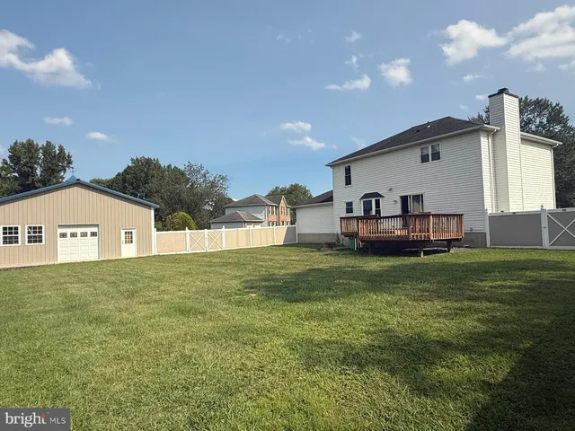a view of a hallway with wooden floor and entryway