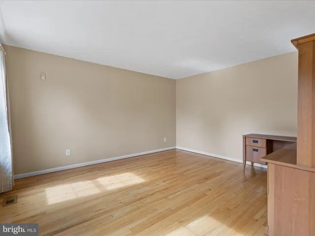 a view of an empty room and a window