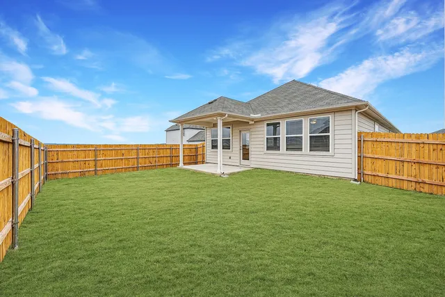 a view of a house with a backyard