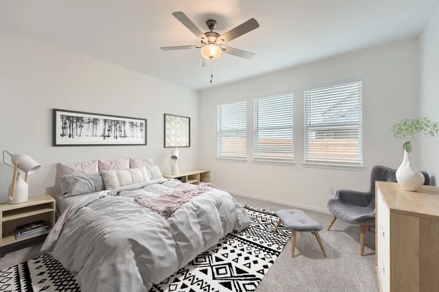 a bedroom with a large bed and a window