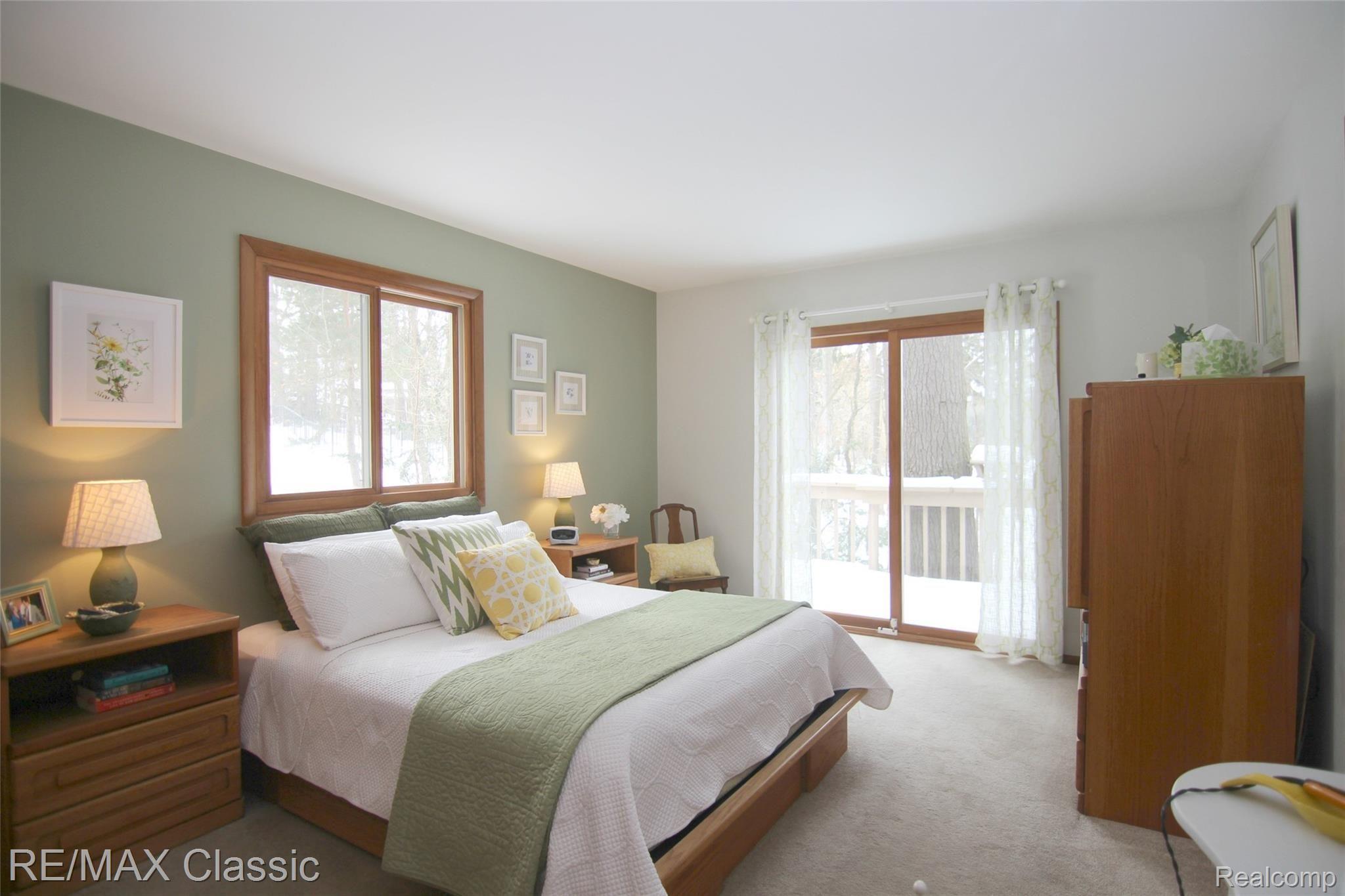 2059 Addaleen Road Highland, MI 48357 - Photo 15 of 33 jAddaleen Rd Master Bedroom With doorwall to deck. Enjoy your morning coffee or tea while watching the wildlife and water.