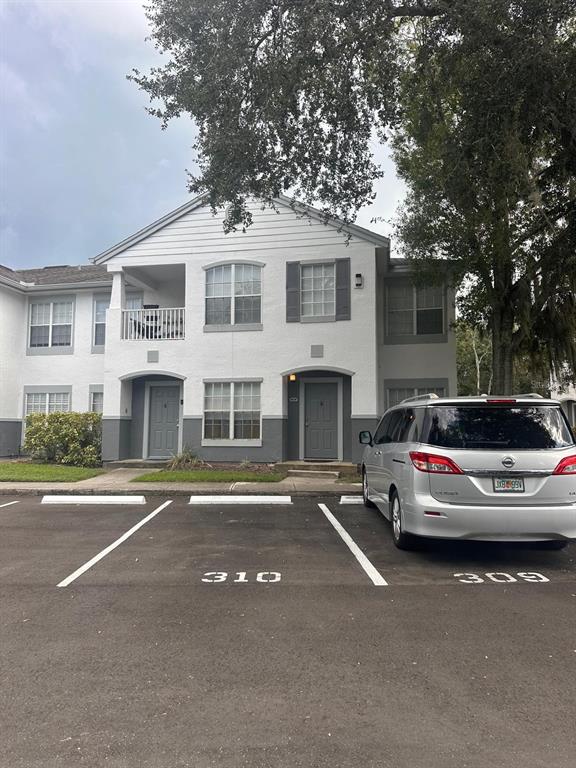 4364 South Kirkman Road, Unit 313 Orlando, FL 32811 - Photo 1 of 27 a car parked in front of a building