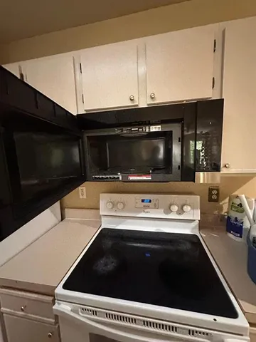 a kitchen with a stove and a microwave
