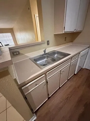 a kitchen with stainless steel appliances granite countertop a stove top oven a sink a counter top space and cabinets