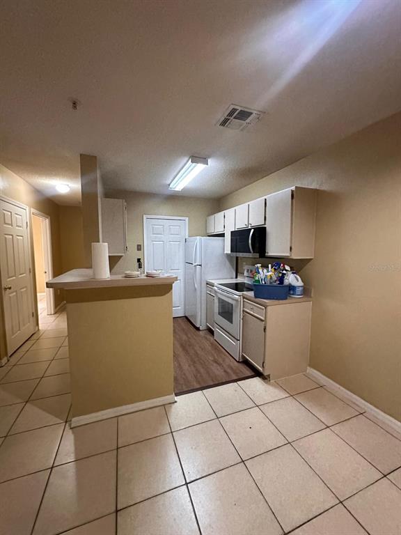 4364 South Kirkman Road, Unit 313 Orlando, FL 32811 - Photo 15 of 27 a kitchen with stainless steel appliances granite countertop a stove top oven a sink a counter top space and cabinets
