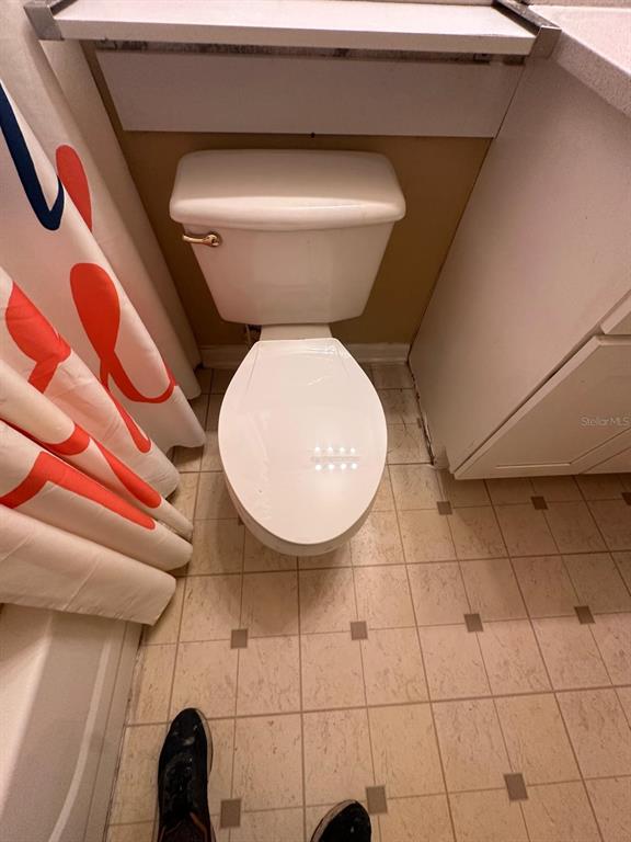 4364 South Kirkman Road, Unit 313 Orlando, FL 32811 - Photo 22 of 27 a bathroom with a toilet and a mirror