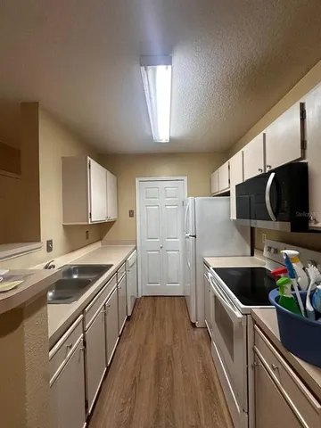 a kitchen with stainless steel appliances granite countertop a sink and a stove