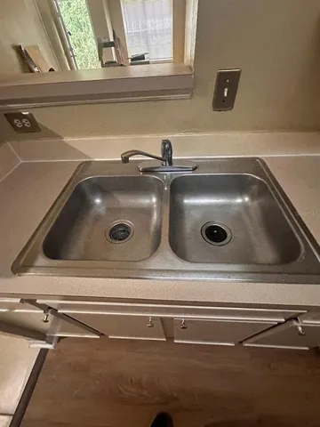 a close view of sink and cabinets