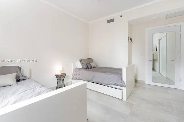 a bedroom with furniture and a flat screen tv