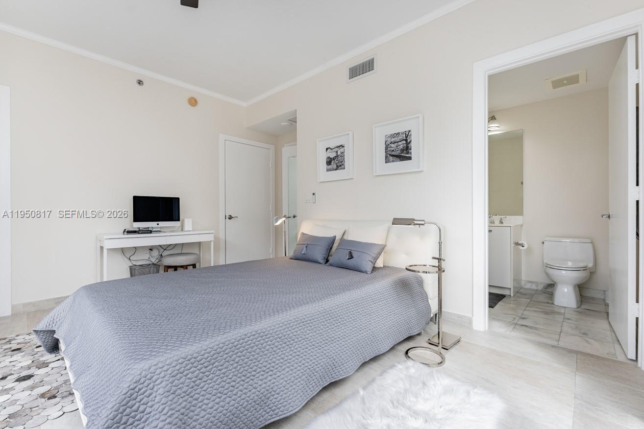 1060 Brickell Avenue, Unit 1507 Miami, FL 33131 - Photo 15 of 56 a bedroom with a bed and a flat screen tv