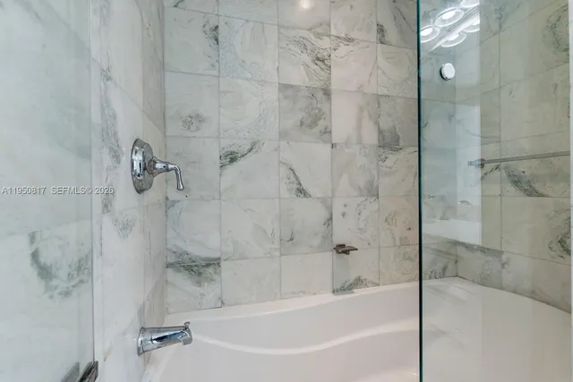 a bedroom with a bed and glass door