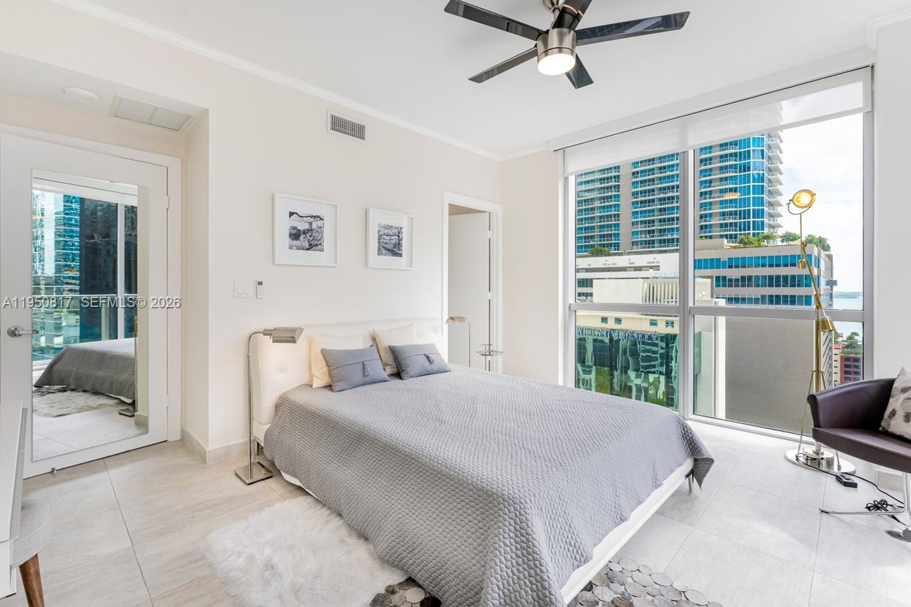 1060 Brickell Avenue, Unit 1507 Miami, FL 33131 - Photo 18 of 56 a bedroom with a bed and glass door